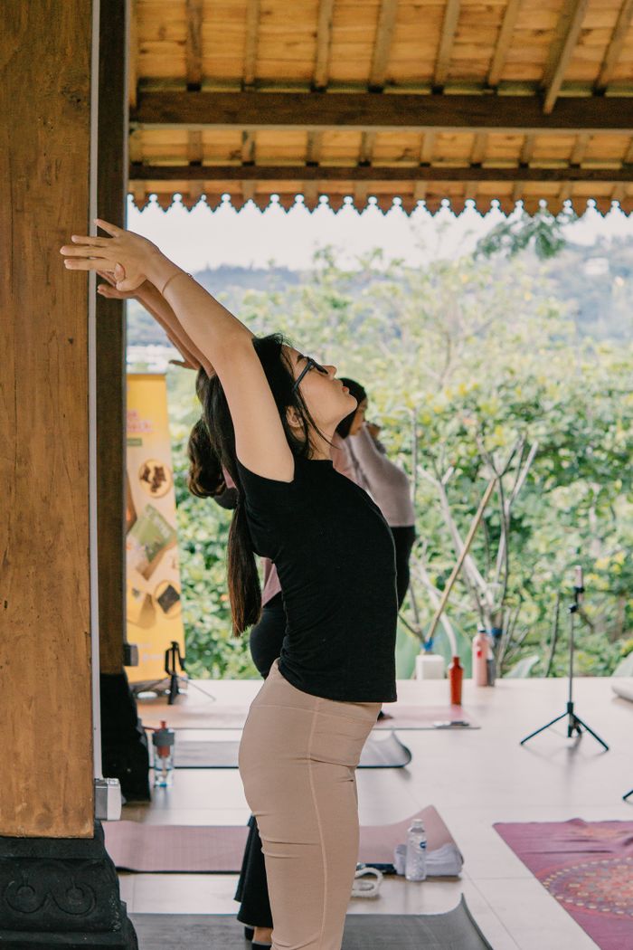 services-01 Woman practicing yoga pose in a serene outdoor setting, Jawa Barat.