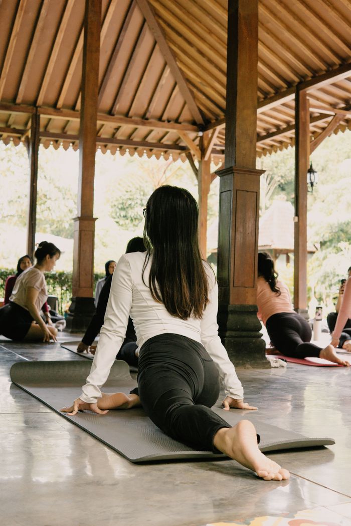services-01 Experience outdoor group yoga at a serene pavilion in Jawa Barat, Indonesia. Perfect for relaxation and fitness.